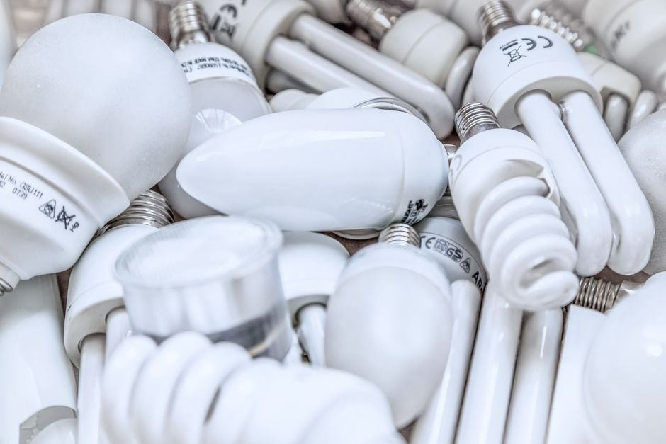 Pile of diverse energy-efficient light bulbs showcasing an array of designs and functionalities.