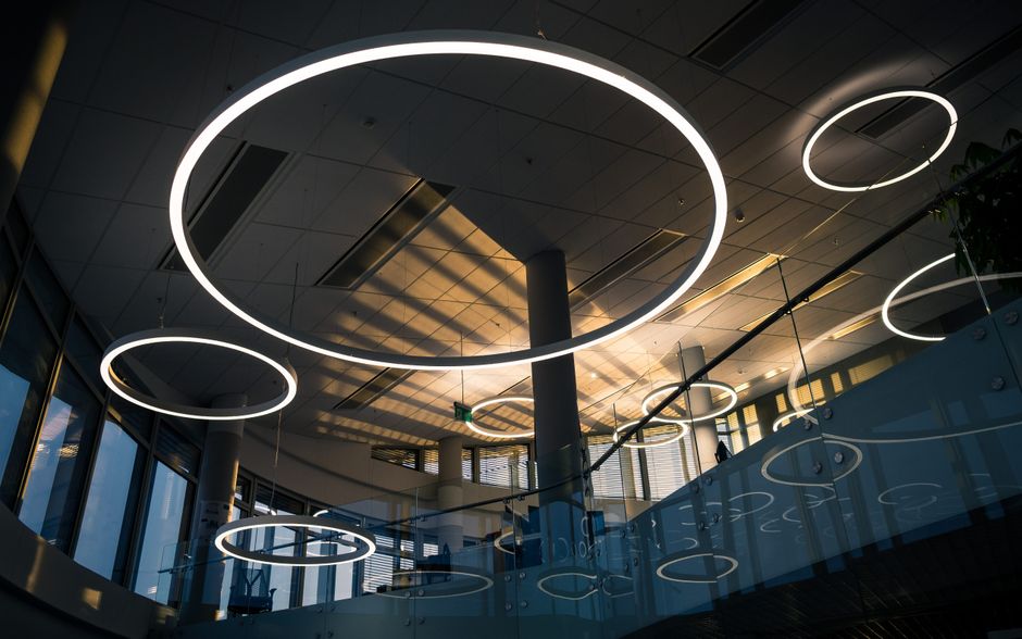Elegant modern interior design featuring circular ceiling lights and glass accents.